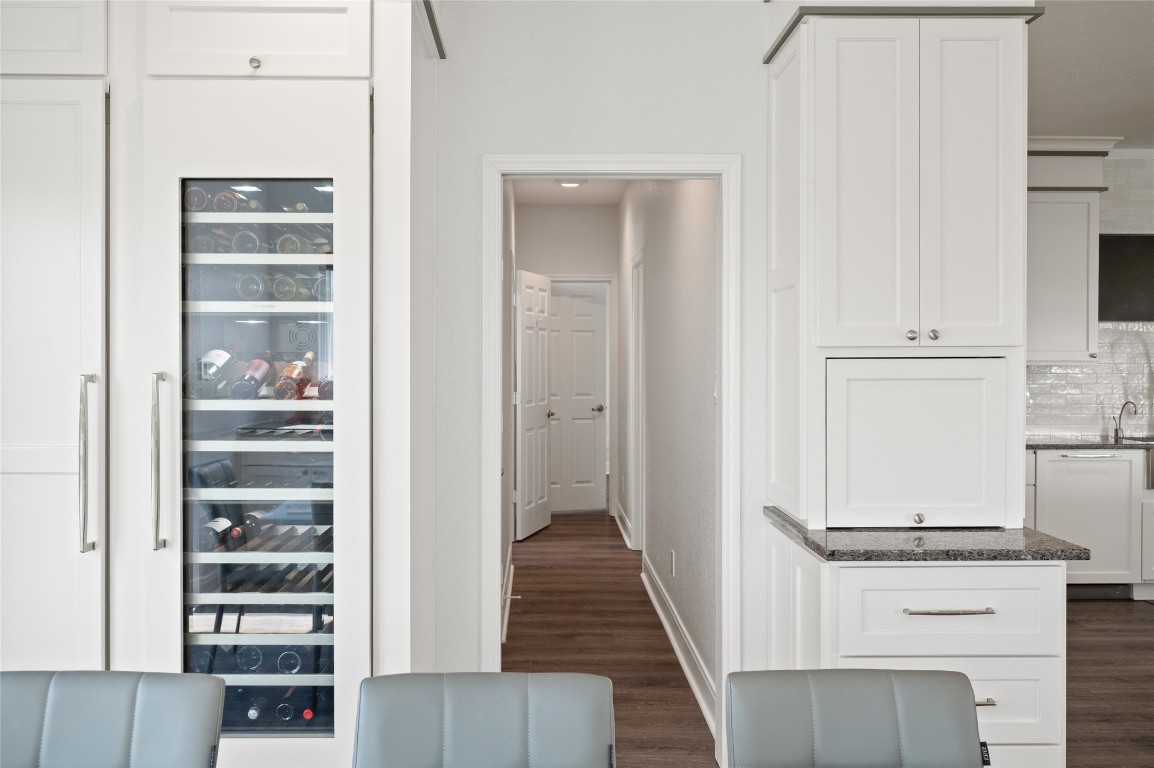 242 Isles End Road Tiki Island, TX 77554 - Photo 9 of 50 This hallway leads to the utility room and flexible extra room that functions well as a home office, bunk room, or nursery.