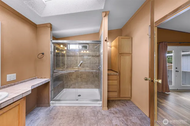 a bathroom with a shower and a sink