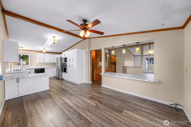 a view of a living room and kitchen with wooden floor