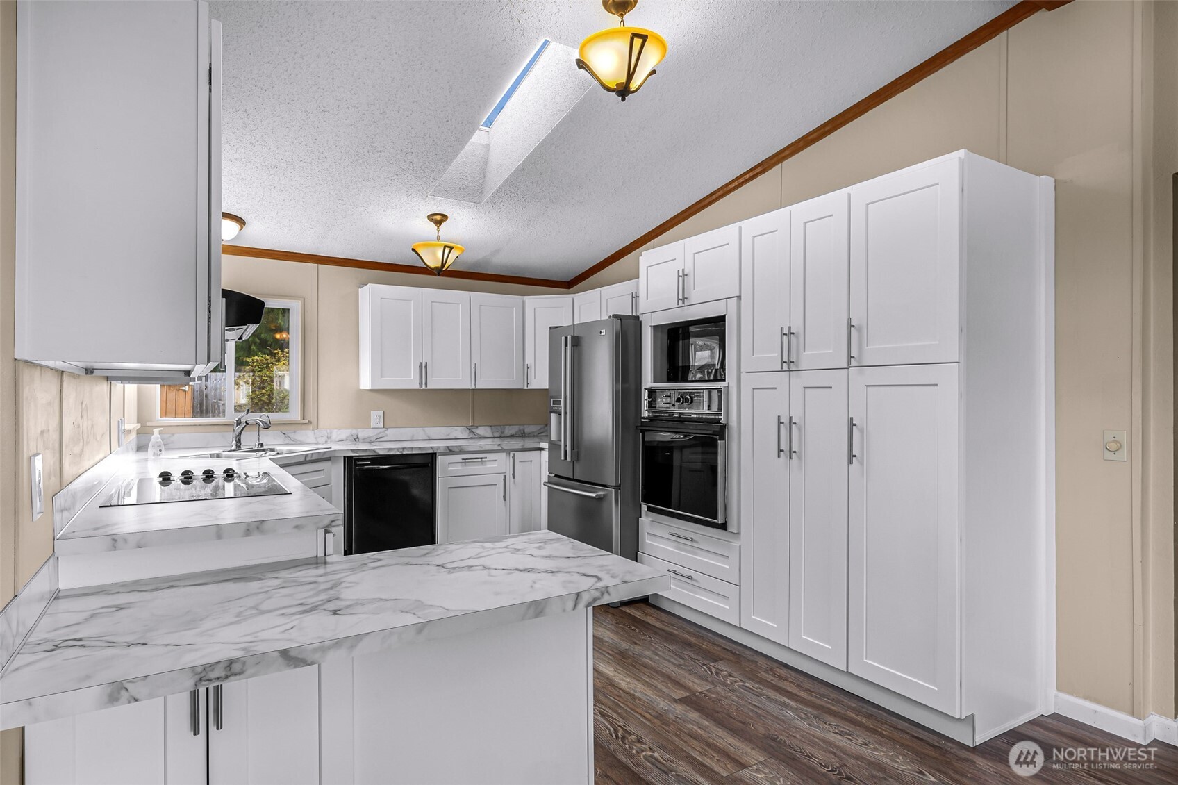 3802 James Street, Unit 23 Bellingham, WA 98226 - Photo 6 of 34 a large white kitchen with a stove a sink dishwasher and a refrigerator with wooden floor