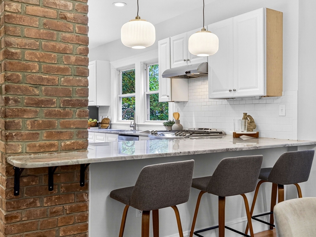 47 Roslin Street, Unit ONE Boston, MA 02124 - Photo 15 of 34 a kitchen with a dining table chairs and sink