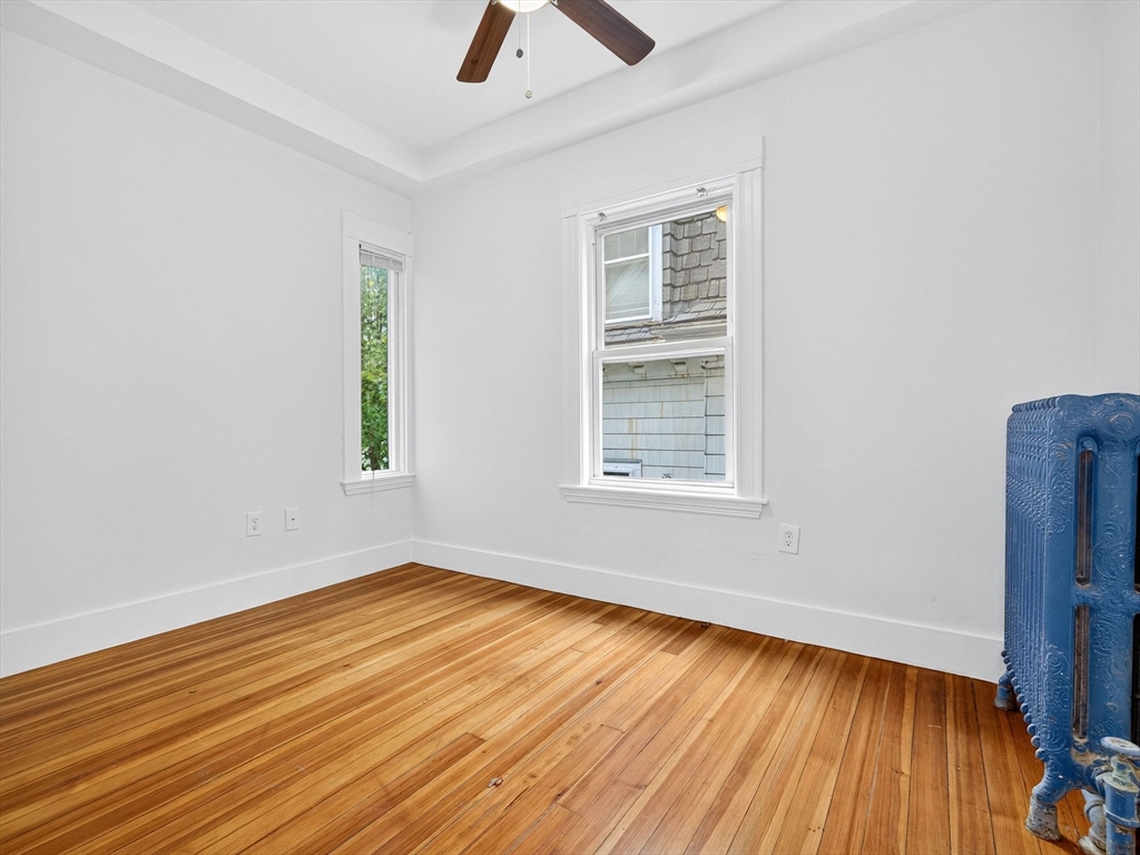 47 Roslin Street, Unit ONE Boston, MA 02124 - Photo 28 of 34 wooden floor in an empty room with a window