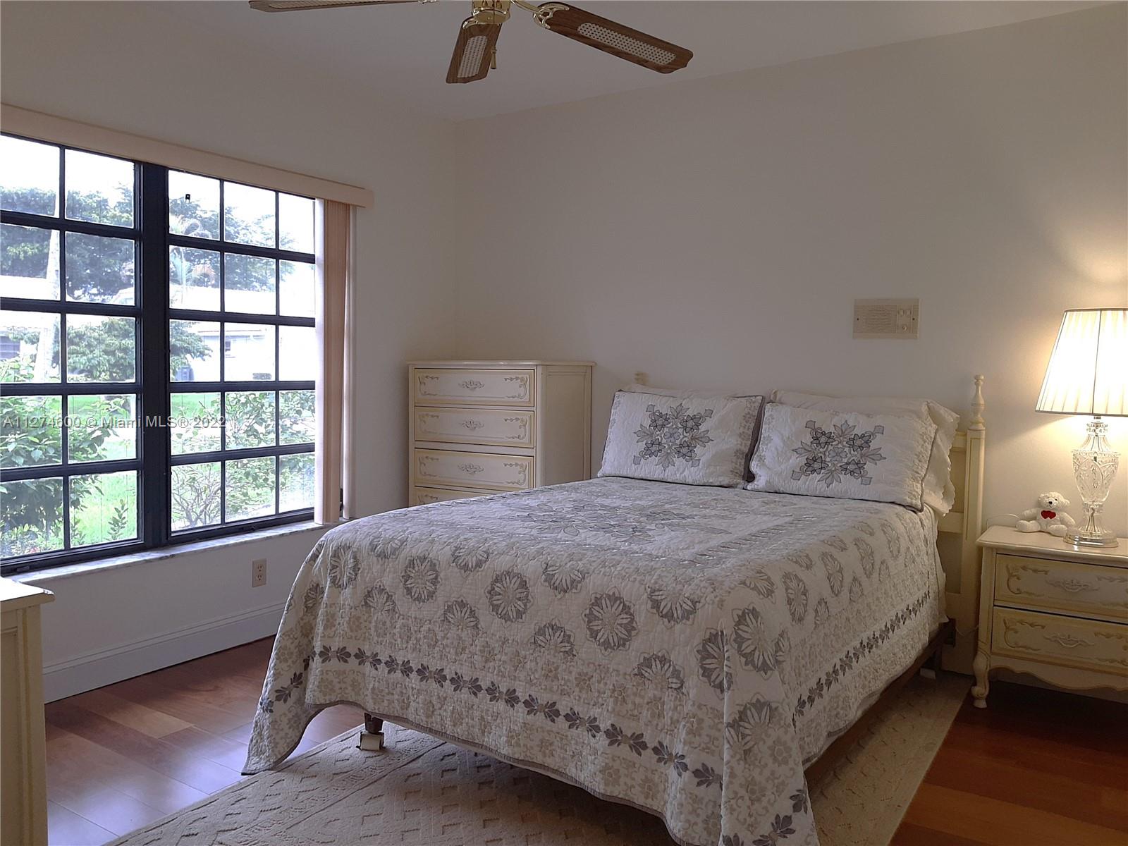 7911 Cloverfield Circle Boca Raton, FL 33433 - Photo 4 of 25 a bedroom with a bed and a window