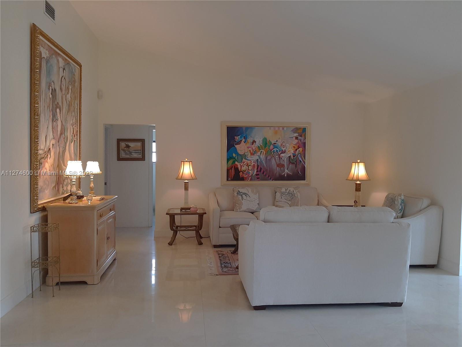 7911 Cloverfield Circle Boca Raton, FL 33433 - Photo 7 of 25 a living room with furniture and a lamp