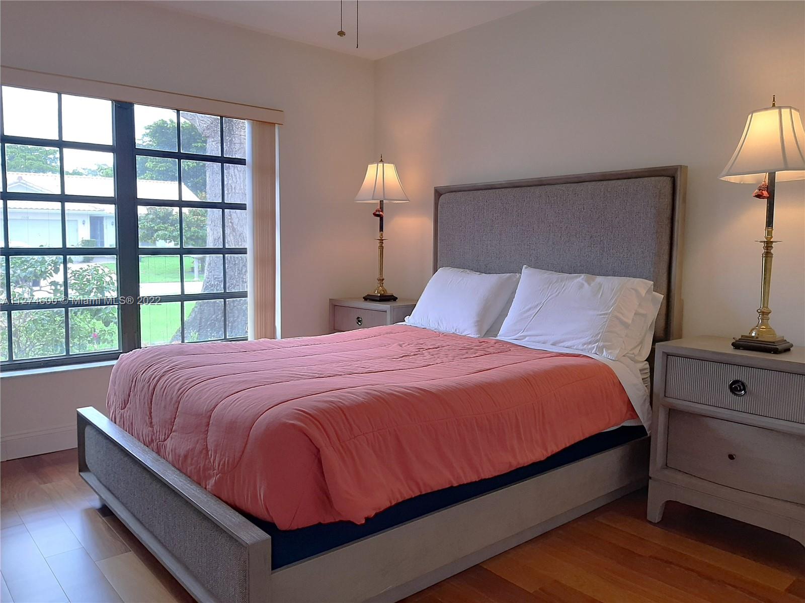 7911 Cloverfield Circle Boca Raton, FL 33433 - Photo 8 of 25 a large bed sitting in a bedroom next to a window