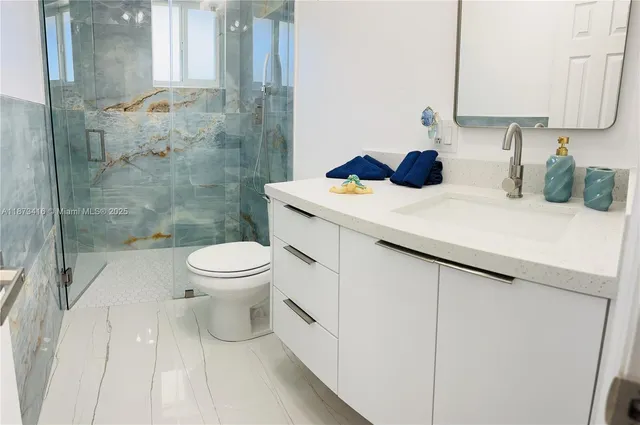a bathroom with a toilet sink and shower