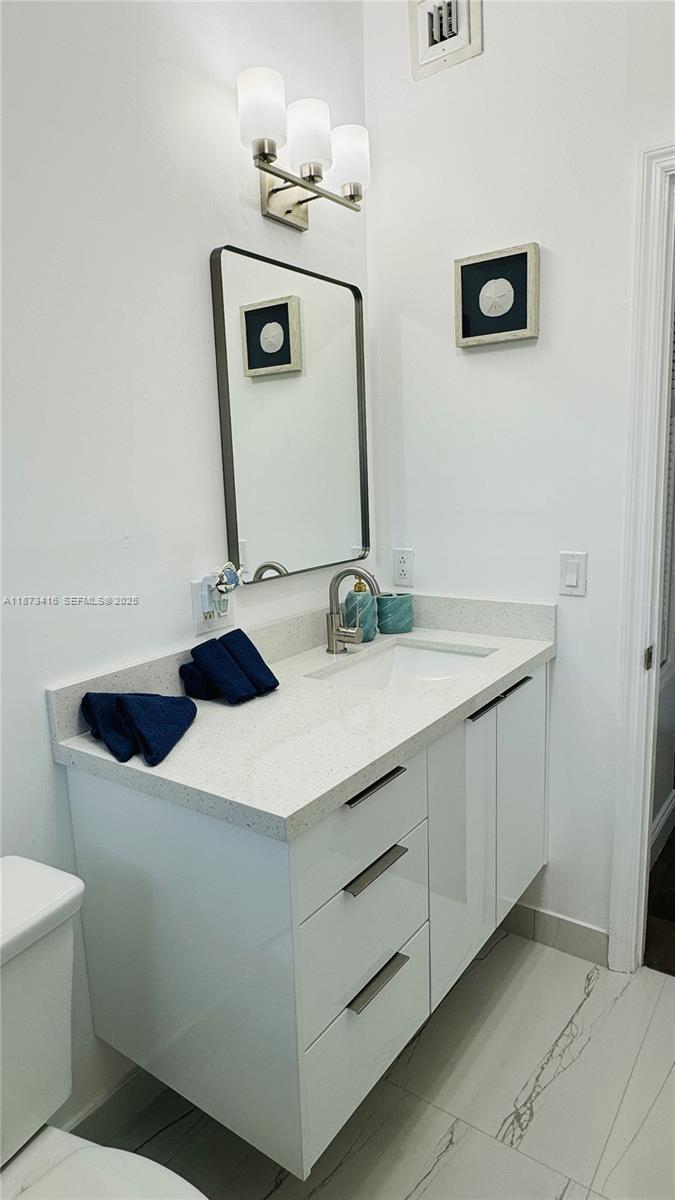 443 4th Road, Unit MAIN Key Largo, FL 33037 - Photo 15 of 31 a bathroom with a sink and a mirror