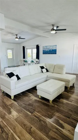 a living room with furniture and a lamp