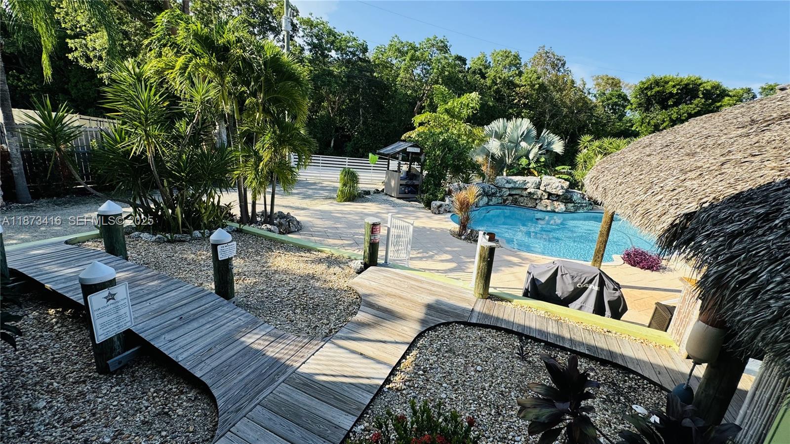 443 4th Road, Unit MAIN Key Largo, FL 33037 - Photo 26 of 31 swimming pool view with plants and large trees