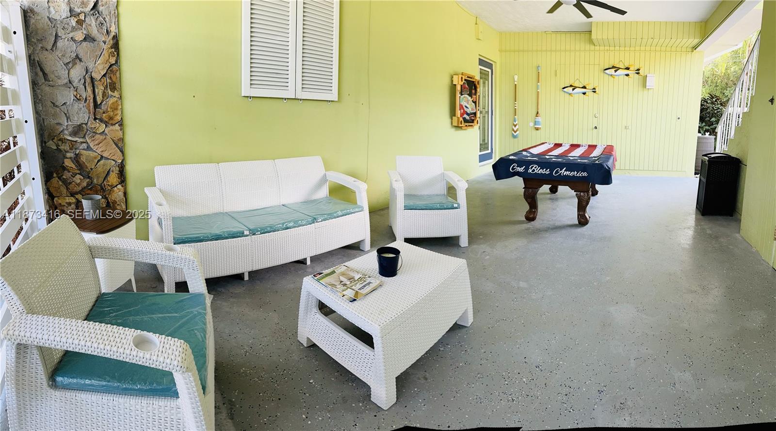 443 4th Road, Unit MAIN Key Largo, FL 33037 - Photo 30 of 31 a living room with furniture and a chandelier