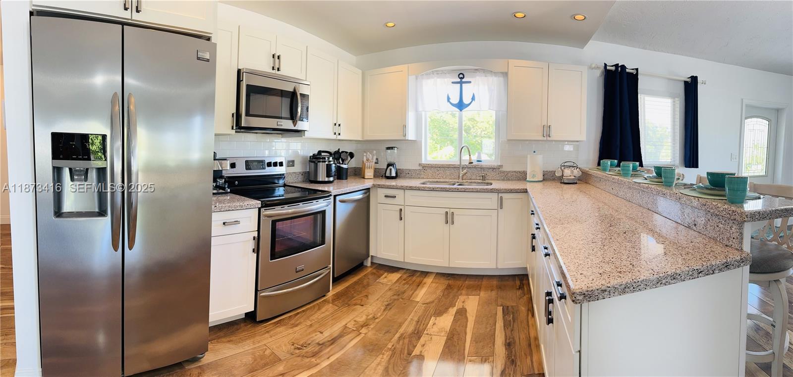 443 4th Road, Unit MAIN Key Largo, FL 33037 - Photo 3 of 31 a kitchen with a sink stove and refrigerator