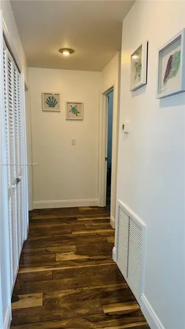 a view of room with wooden floor and staircase
