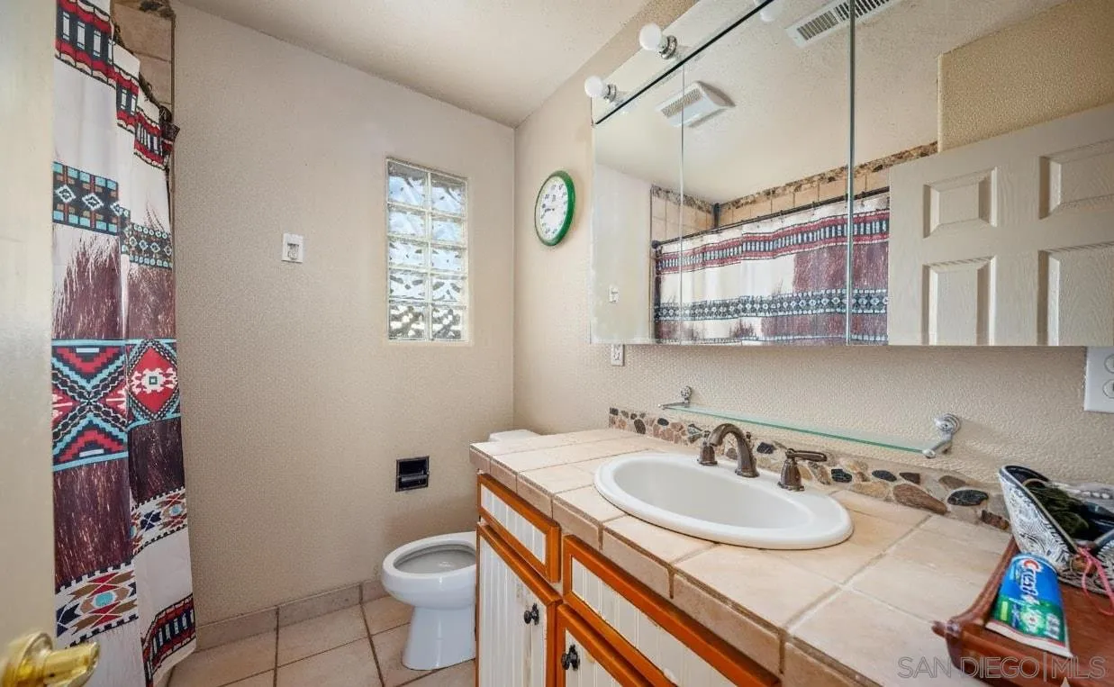 31141 Saddleback Road Valley Center, CA 92082 - Photo 11 of 23 a bathroom with a sink toilet and a mirror