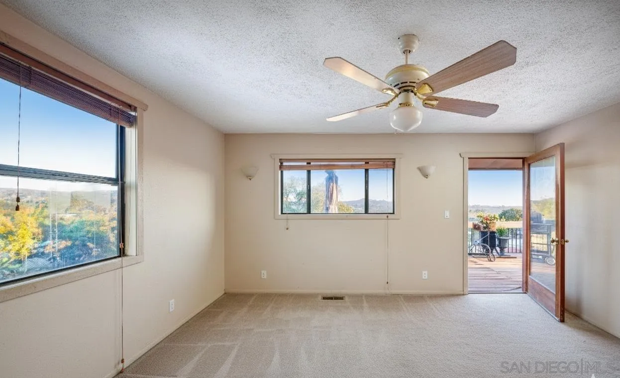 31141 Saddleback Road Valley Center, CA 92082 - Photo 13 of 23 an empty room with windows and fan
