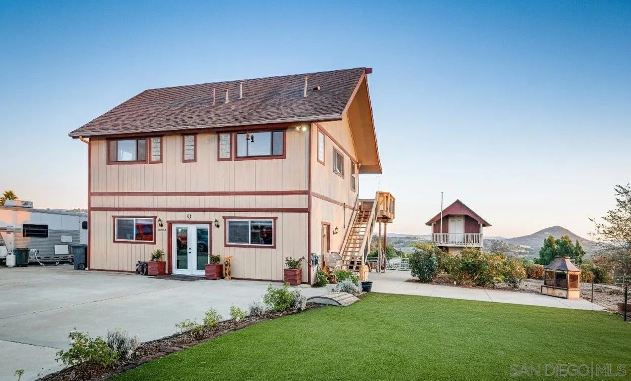 31141 Saddleback Road Valley Center, CA 92082 - Photo 3 of 23 a front view of a house with a yard and garage
