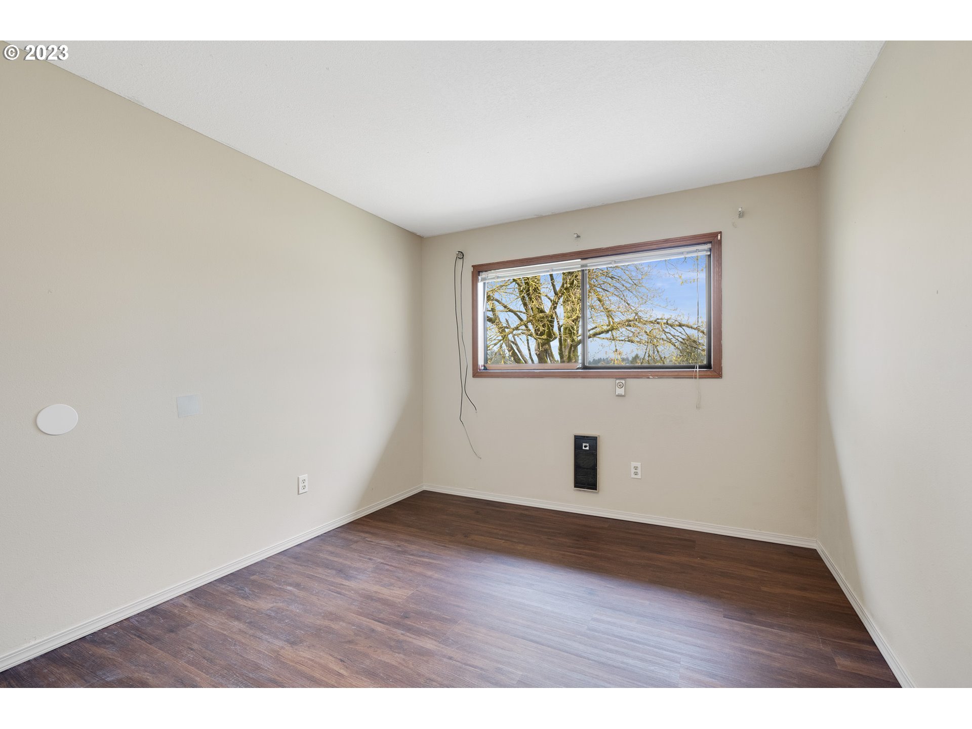 8025 Long Prairie Road Tillamook, OR 97141 - Photo 20 of 41 a view of an empty room with wooden floor and a window