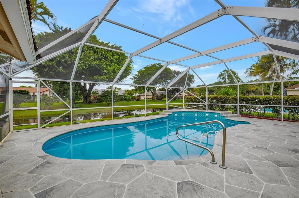 18300 181st Circle South Boca Raton, FL 33498 - Photo 2 of 2 a view of a swimming pool with a lounge chairs