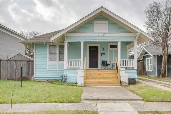 an empty room with wooden floor ceiling fan and windows