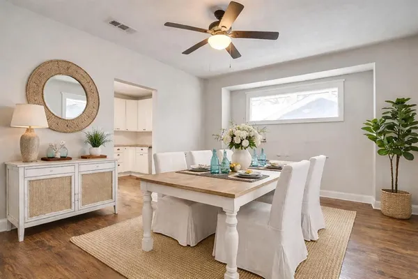 an empty room with wooden floor and a ceiling fan