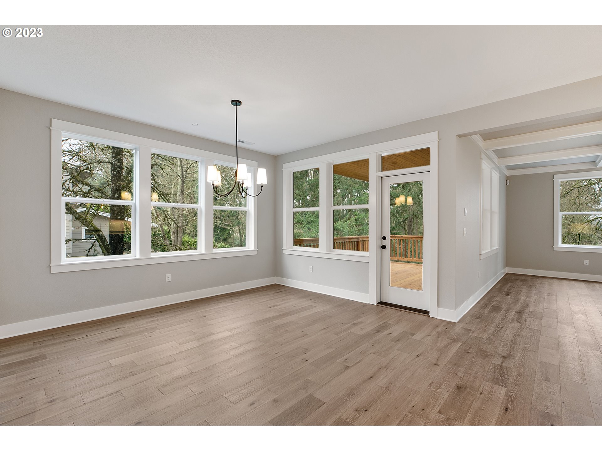 8651 Southwest 42nd Avenue Portland, OR 97219 - Photo 11 of 30 a view of an empty room with wooden floor and windows