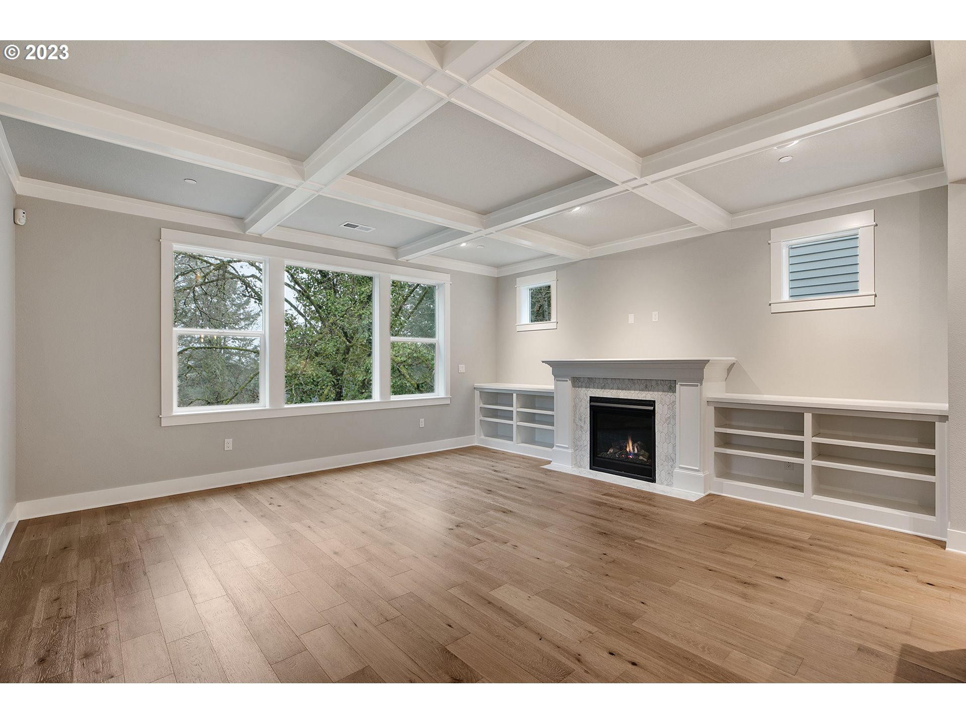 8651 Southwest 42nd Avenue Portland, OR 97219 - Photo 13 of 30 a view of empty room with wooden floor and fireplace
