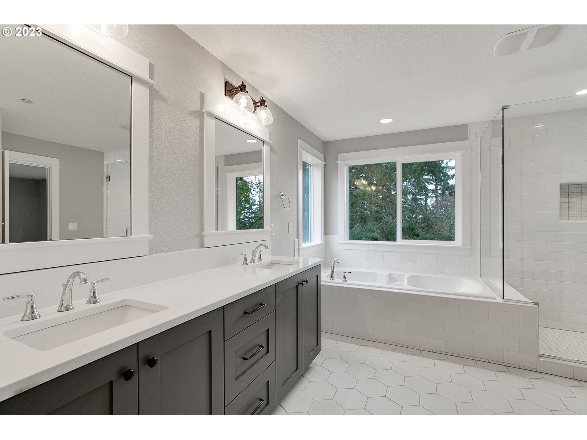 8651 Southwest 42nd Avenue Portland, OR 97219 - Photo 18 of 30 a bathroom with a tub double sink window and mirror