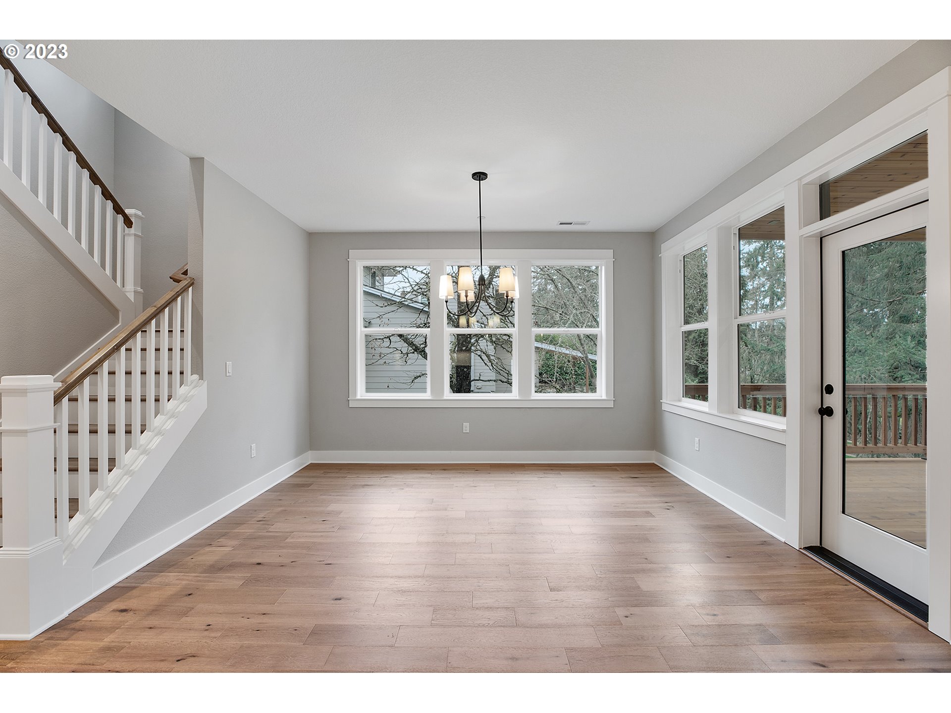 8651 Southwest 42nd Avenue Portland, OR 97219 - Photo 10 of 30 a view of an empty room with wooden floor and a window