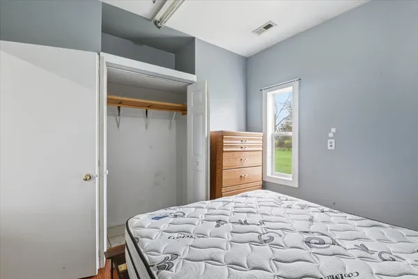 a bedroom with a bed and a dresser