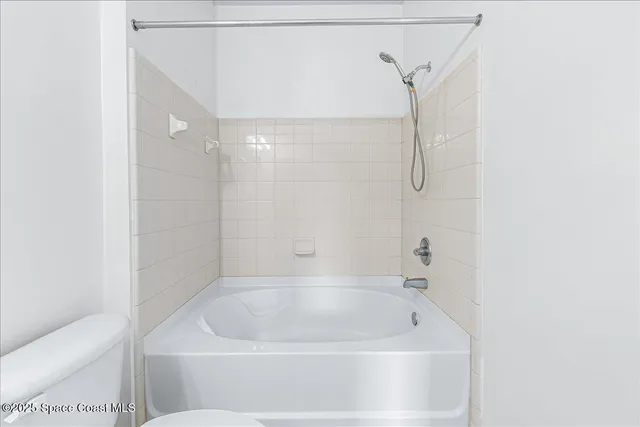 a bathroom with a tub and shower