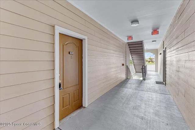 a view of a hallway to rooms