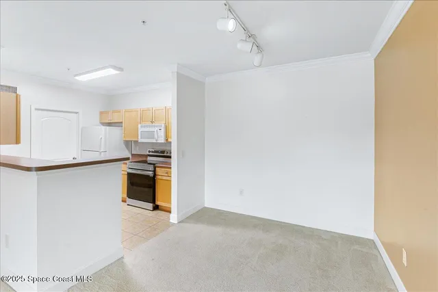 a kitchen with granite countertop a refrigerator and a stove