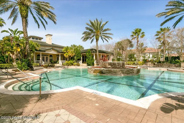 a view of a swimming pool with a garden and plants