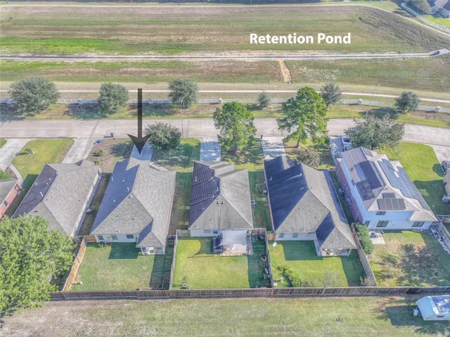 a aerial view of a house with swimming pool and a yard