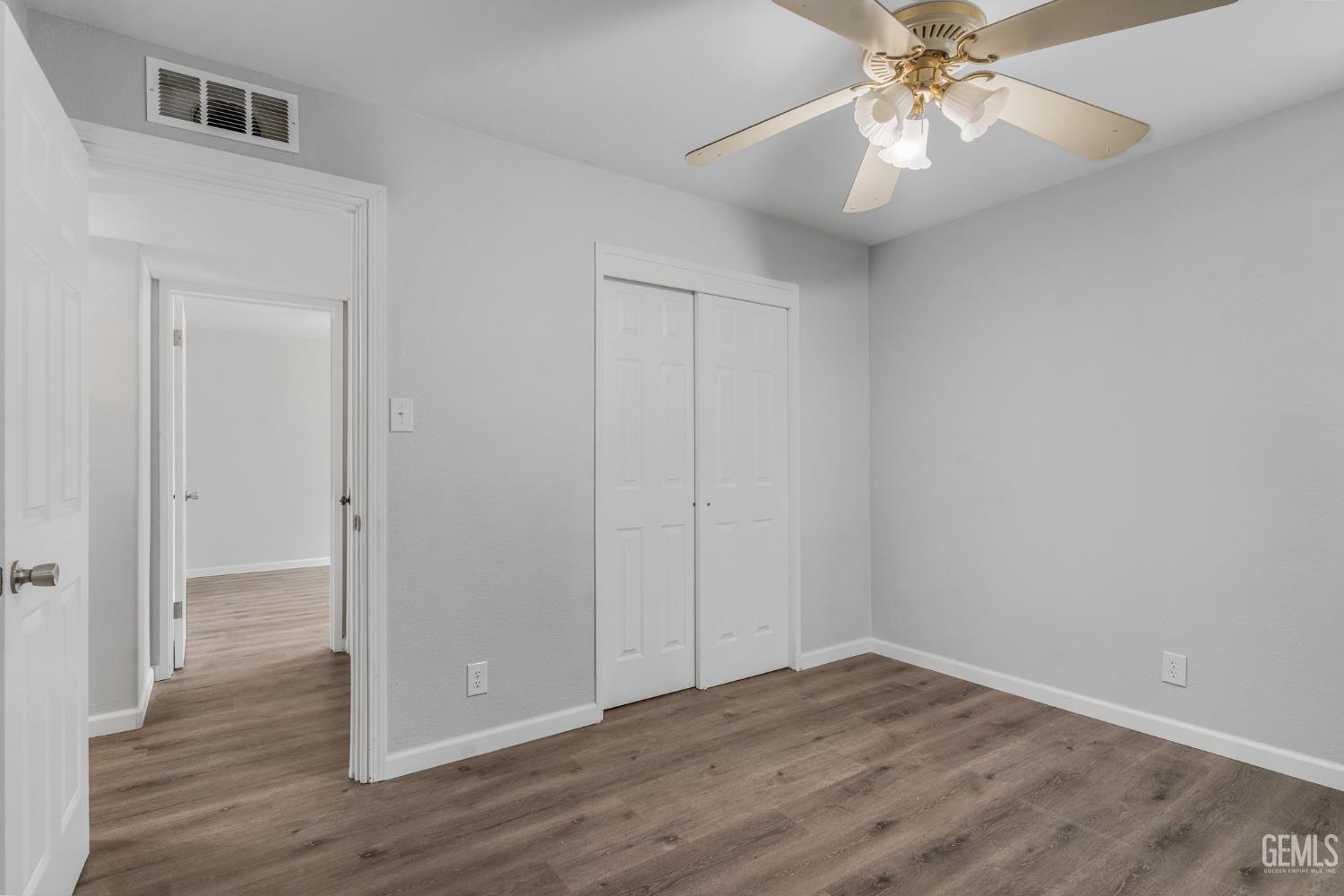Undisclosed Address Bakersfield, CA 93305 - Photo 11 of 21 a view of an empty room with wooden floor
