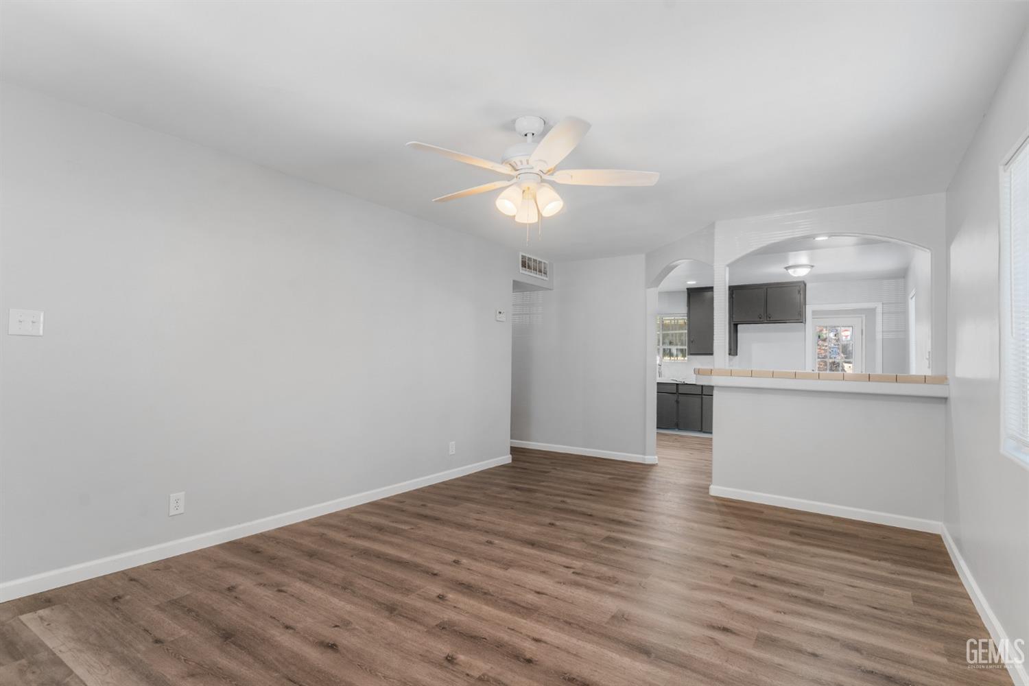 Undisclosed Address Bakersfield, CA 93305 - Photo 14 of 21 a view of an empty room with window and wooden floor