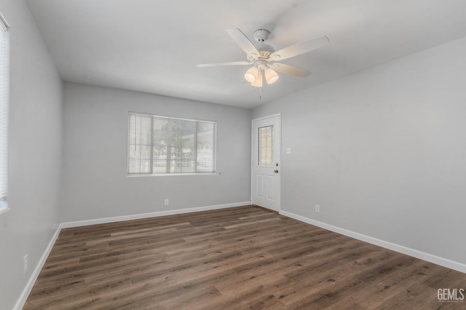 Undisclosed Address Bakersfield, CA 93305 - Photo 15 of 21 a view of an empty room with wooden floor and a window