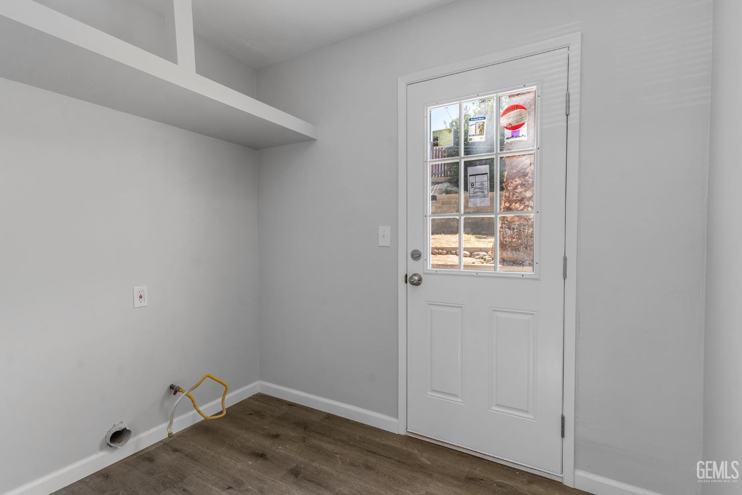 Undisclosed Address Bakersfield, CA 93305 - Photo 19 of 21 a view of an empty room with wooden floor and a window