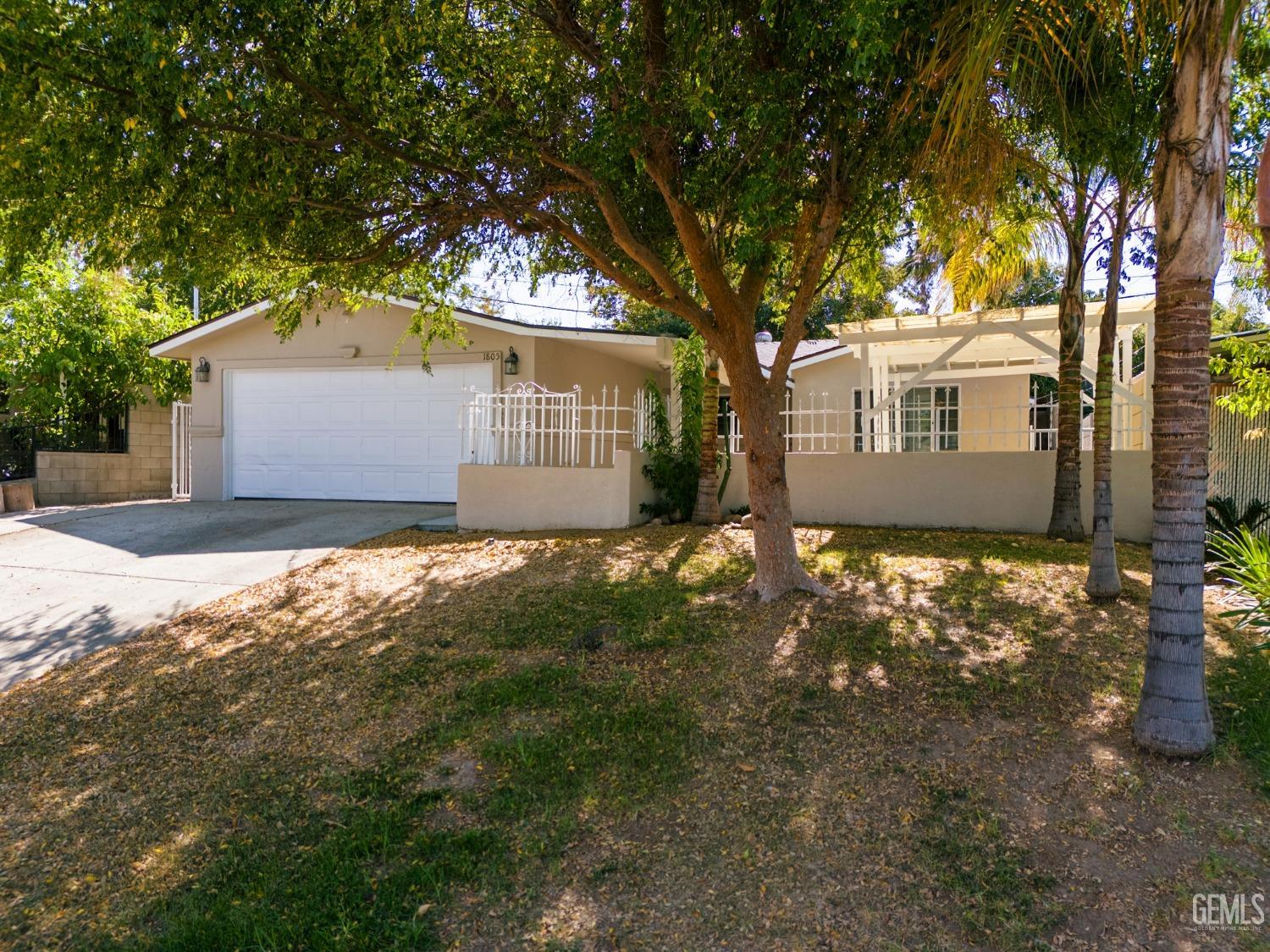 Undisclosed Address Bakersfield, CA 93305 - Photo 2 of 21 a front view of house with yard and trees around