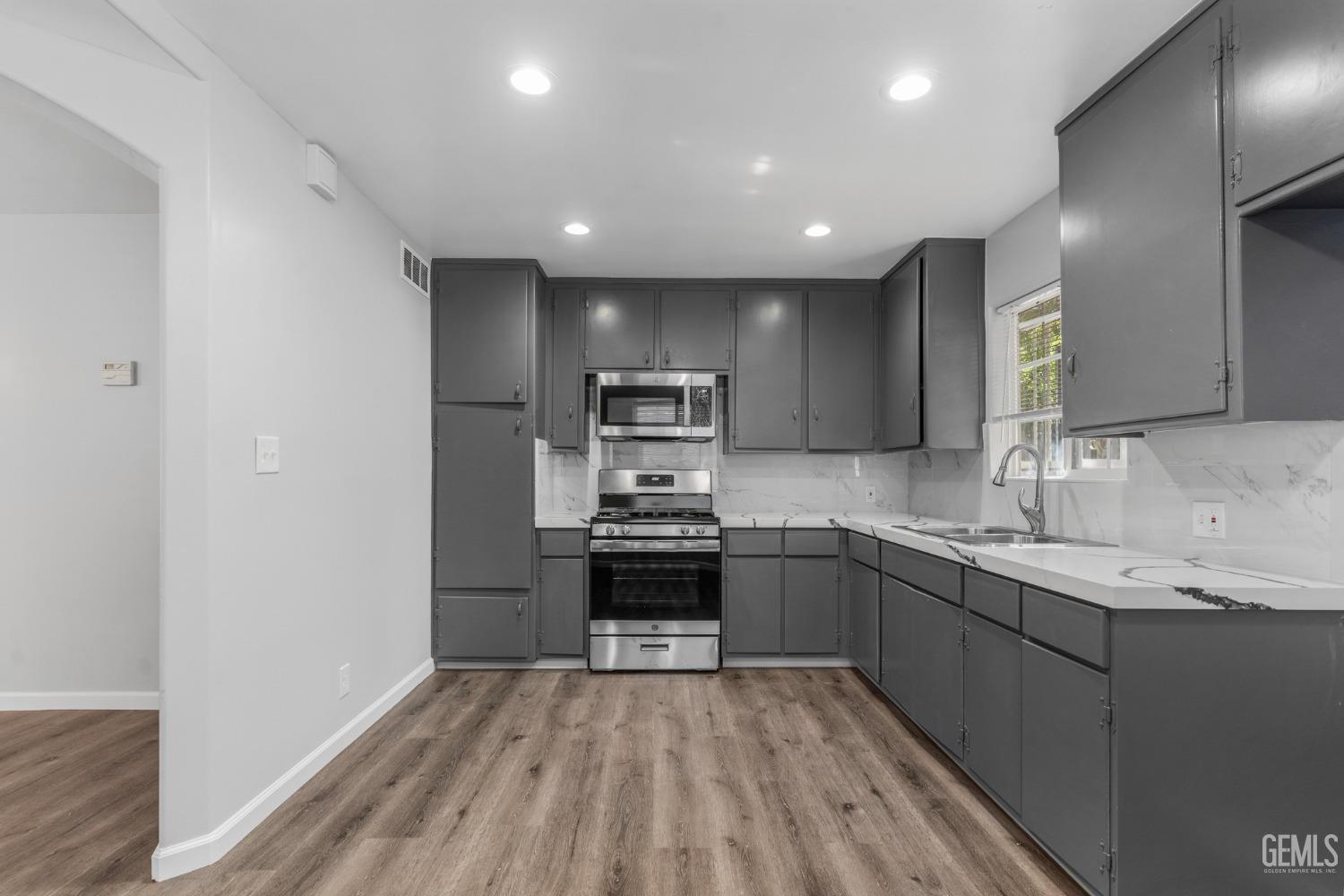 Undisclosed Address Bakersfield, CA 93305 - Photo 4 of 21 a kitchen with stainless steel appliances granite countertop refrigerator sink and stove