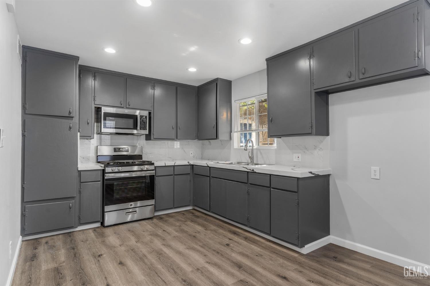 Undisclosed Address Bakersfield, CA 93305 - Photo 5 of 21 a kitchen with stainless steel appliances granite countertop a sink and a stove