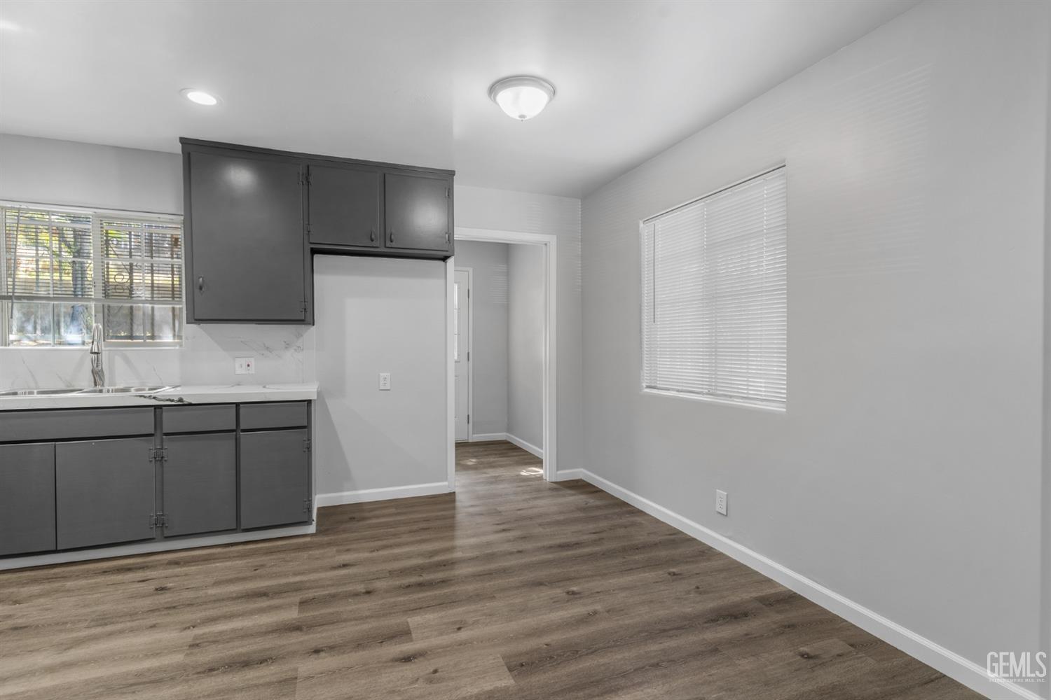 Undisclosed Address Bakersfield, CA 93305 - Photo 6 of 21 a view of a kitchen with a sink and wooden floor