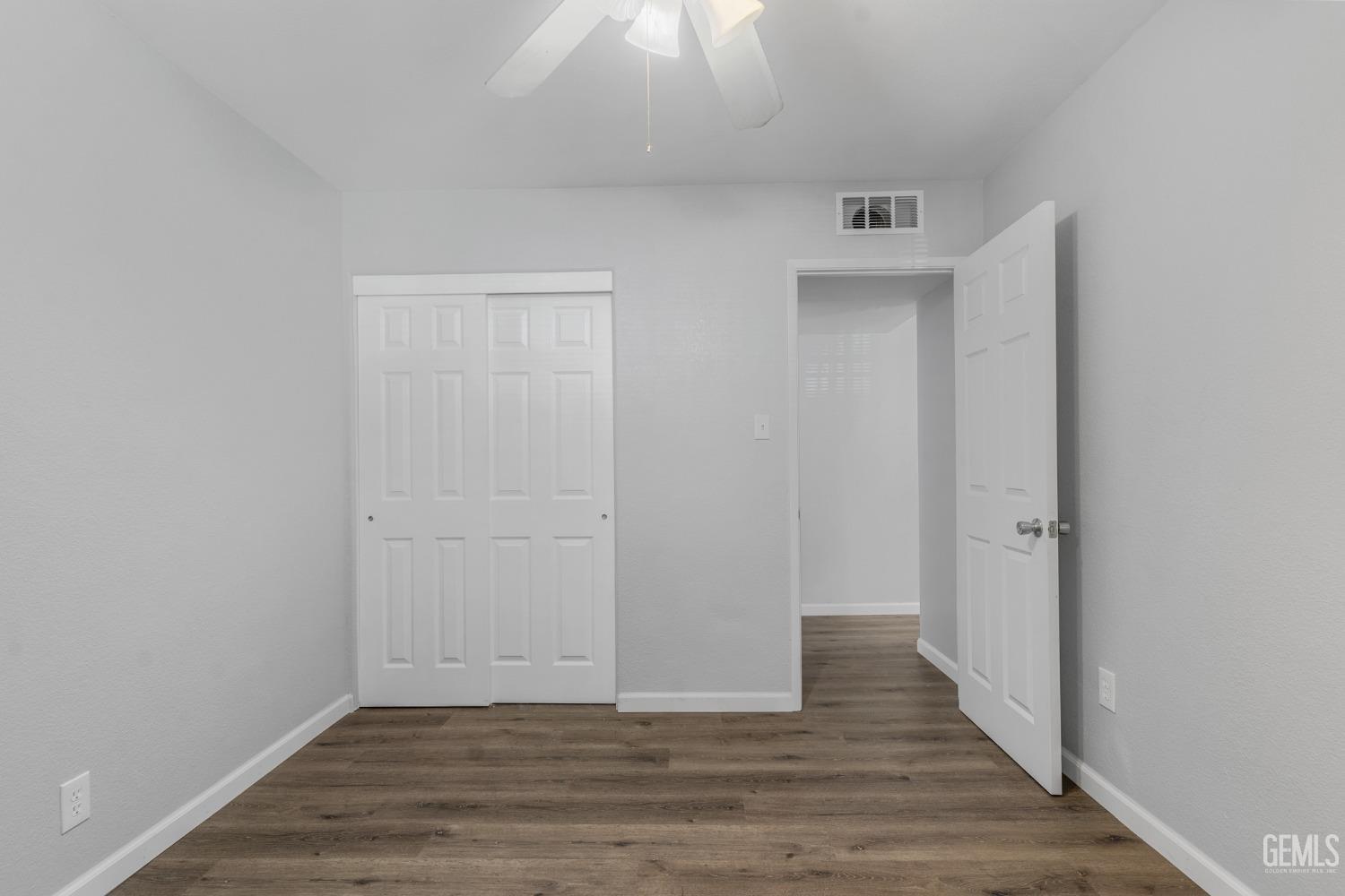 Undisclosed Address Bakersfield, CA 93305 - Photo 8 of 21 a view of an empty room with wooden floor