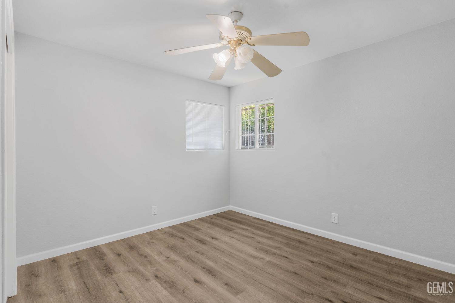 Undisclosed Address Bakersfield, CA 93305 - Photo 10 of 21 wooden floor in an empty room with a window