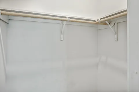 a bathroom with a granite countertop sink a toilet and a mirror