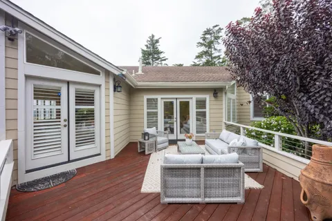 a balcony with furniture and wooden floor