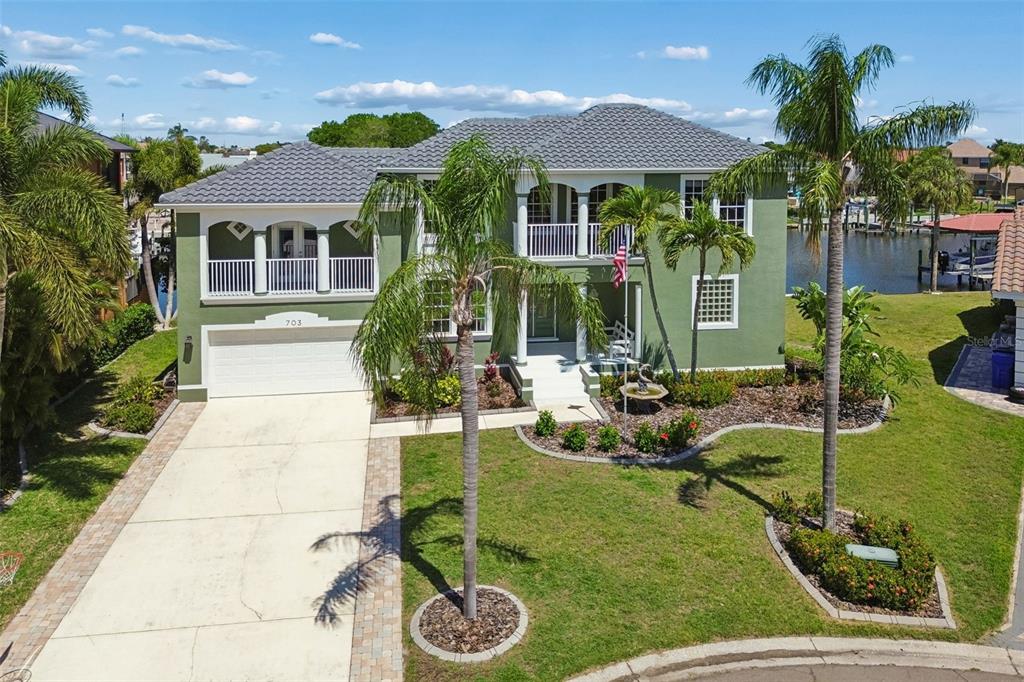 703 Bunker View Drive Apollo Beach, FL 33572 - Photo 46 of 49 a front view of house with yard and outdoor seating
