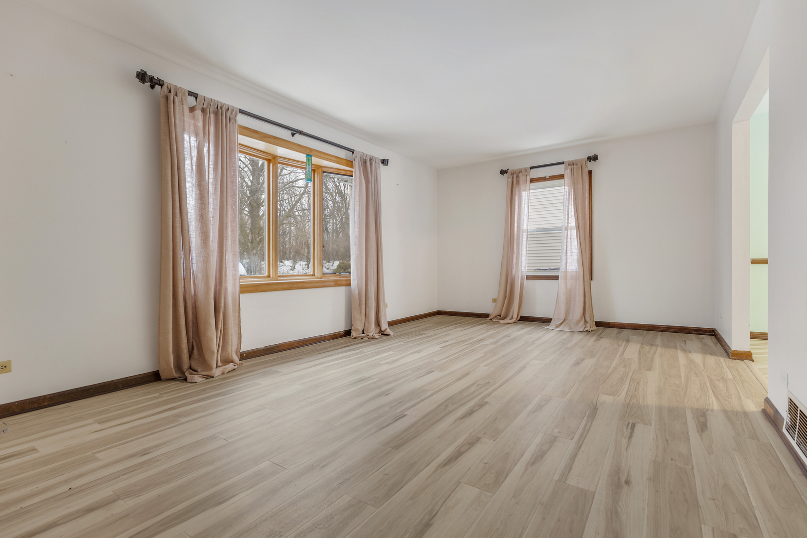 720 Ash Street Algonquin, IL 60102 - Photo 3 of 25 an empty room with wooden floor and windows