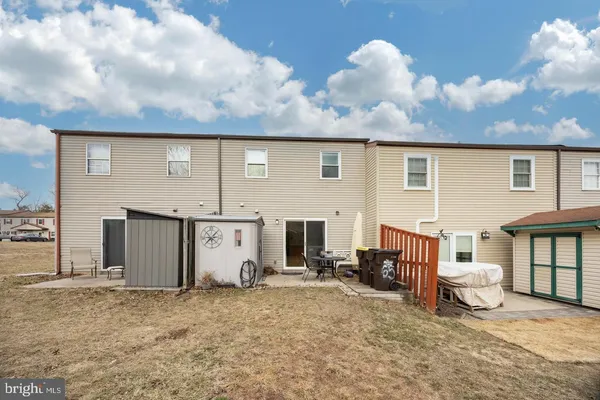 a view of a house with a backyard and a garage