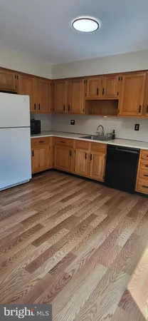 a kitchen with stainless steel appliances granite countertop a sink and cabinets