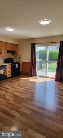 a view of a kitchen with a sink and a large window